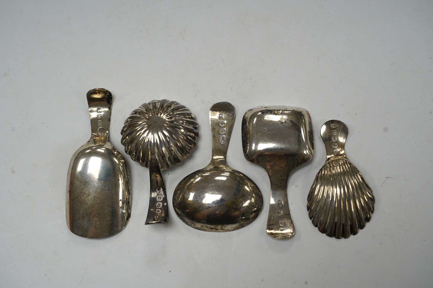 Five assorted silver caddy spoons, including shovel shape by Cocks & Bettridge, Birmingham, 1808, 71mm, oval bowl, John Blake, London, 1804, square bow, Joseph Wilmore, Birmingham, 1810, shell bowl, Joseph Taylor, Birmin